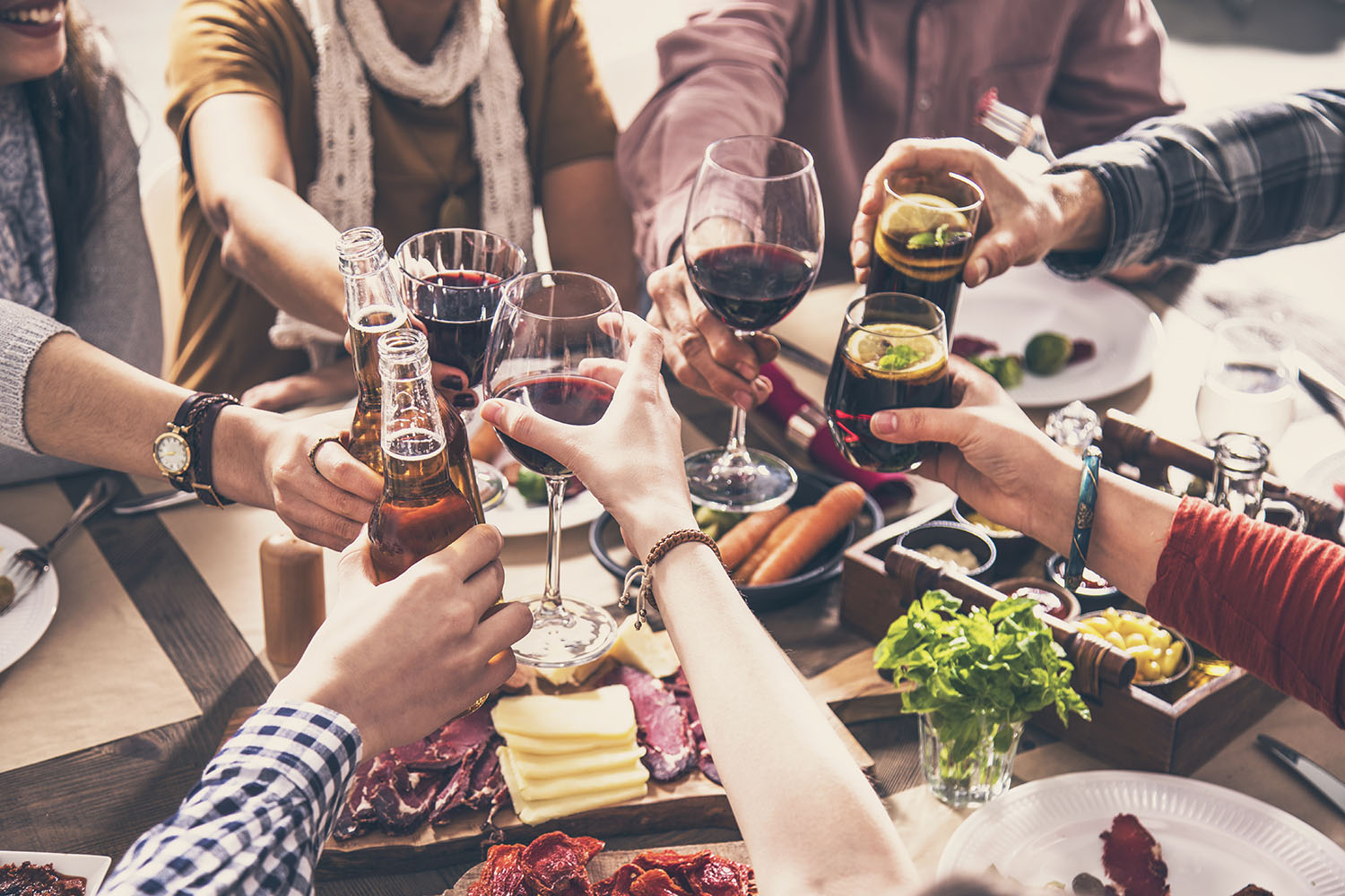 Group of people having meal togetherness dining toasting glasses